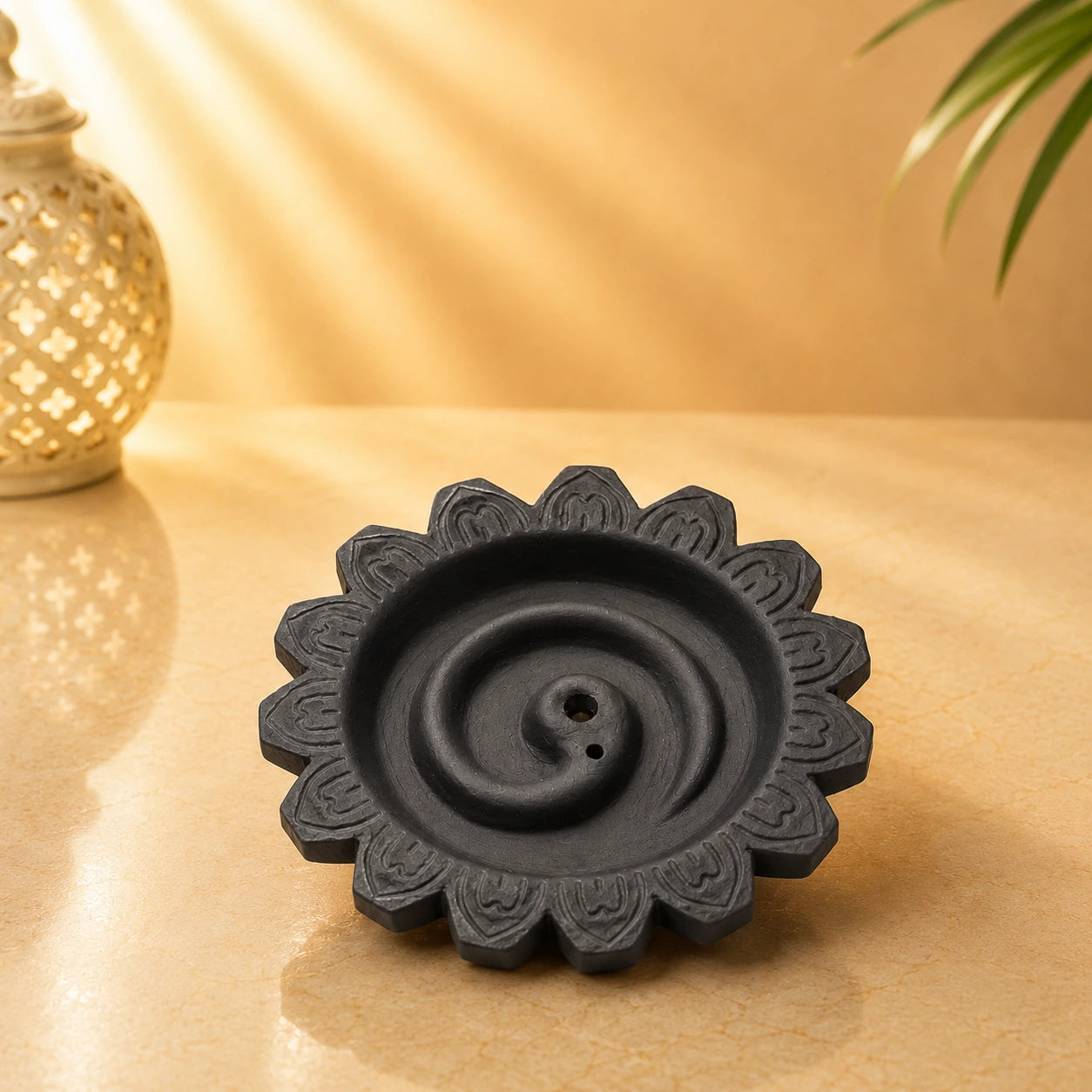 Leela black clay rope incense burner with a spiral channel, lotus-shaped rim and two incense holes