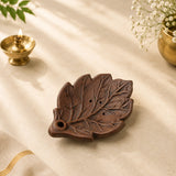 Leela handmade leaf-shaped clay incense holder in a dark brown finish with carved vein details