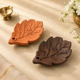 Leela handmade leaf-shaped clay incense holders in terracotta and dark brown finishes