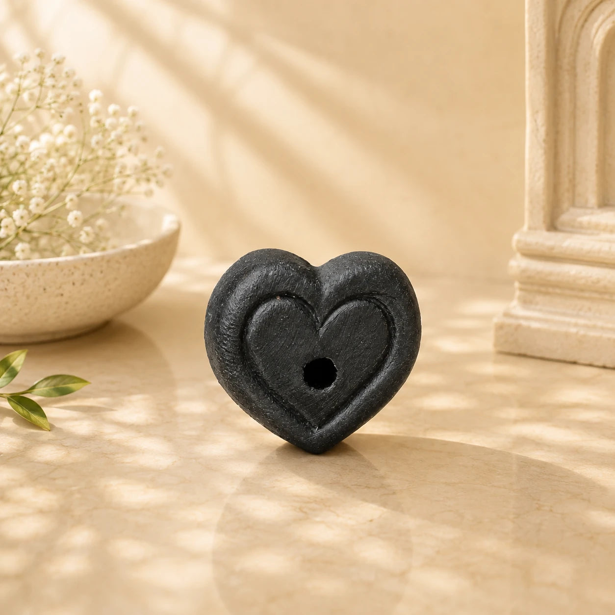 Leela mini black clay incense burner with a heart-shaped design and central incense opening