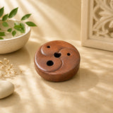 Leela mini round terracotta clay incense burner with a raised yin-yang design and three incense openings