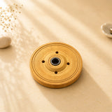 Leela plain round wooden Tibetan incense burner with concentric grooves, four ventilation holes and a central incense holder.