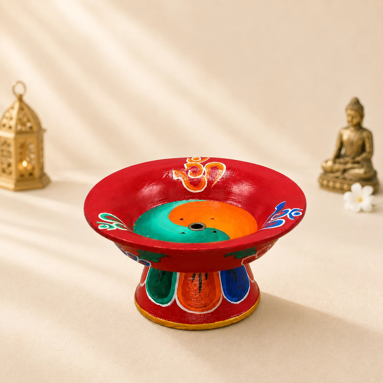 Leela red hand-painted Tibetan incense burner with colourful Om symbols, a yin-yang design and a central incense holder.