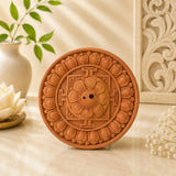 Leela round saffron terracotta incense holder with an intricately carved lotus mandala design and central incense openings