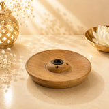 Leela small round wooden incense burner with a central holder and three ventilation holes.