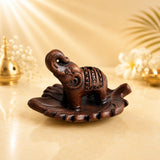 Leela terracotta incense burner featuring a carved elephant with a raised trunk on a decorative leaf-shaped tray.