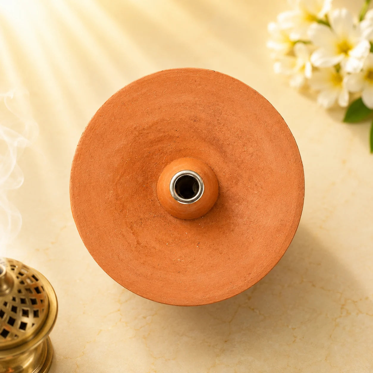 Top view of the Leela terracotta Gompa incense burner featuring a wide circular bowl and raised central incense-stick holder.