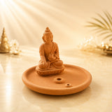 Leela terracotta incense burner featuring a meditating Buddha on a round ash-catching tray with two incense-stick holes.