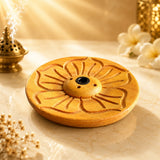 Leela Tibetan wooden incense burner featuring an intricately carved lotus design, central brass holder and four incense-stick holes.